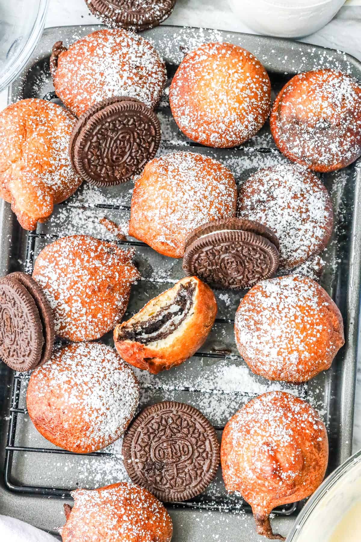fried oreos on cooking wire rack dusted with powdered sugar