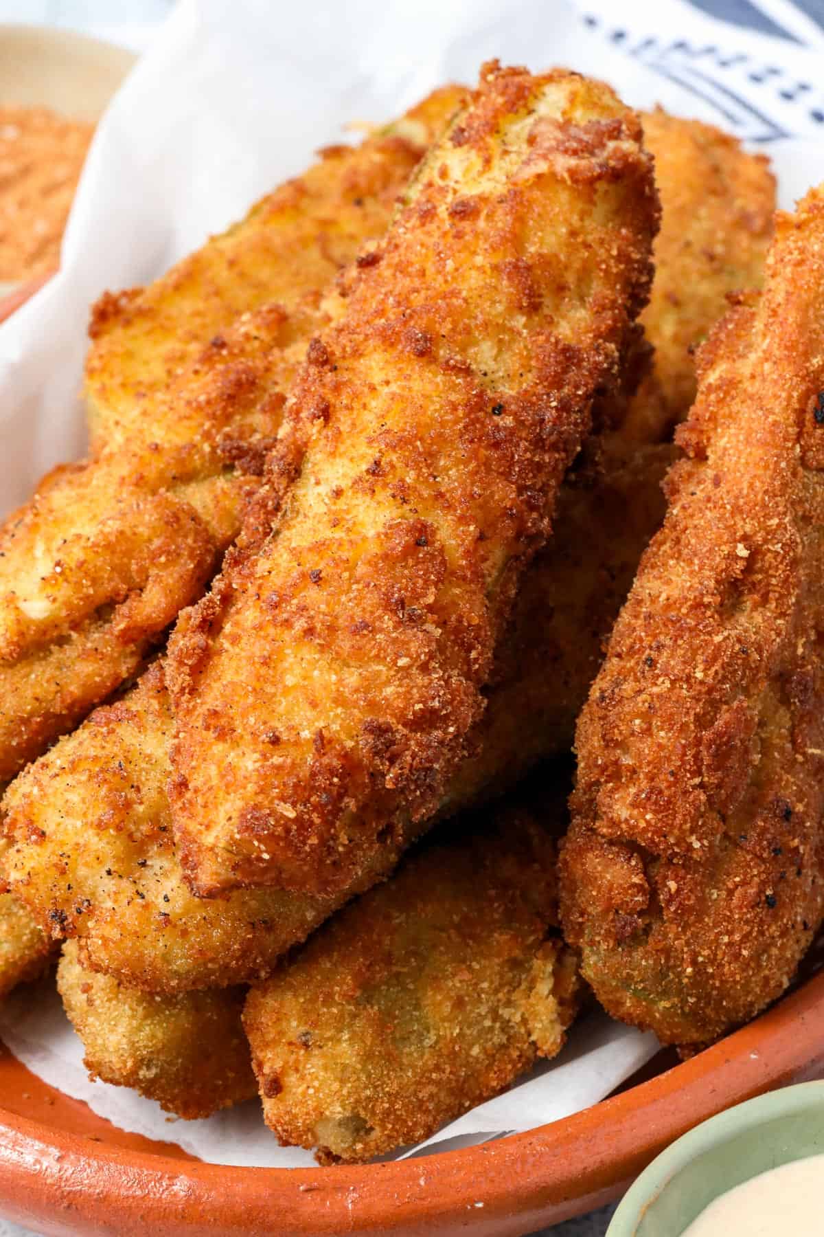 Fried Pickle Spears stacked on top of each other.