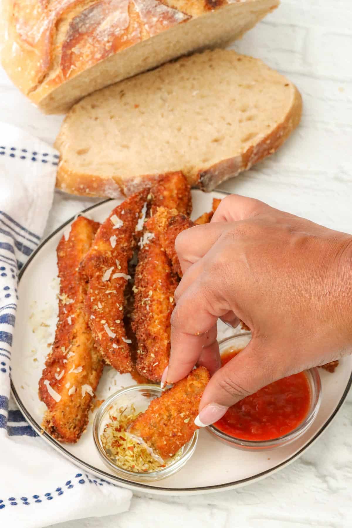 dipping sourdough breadsticks in olive oil