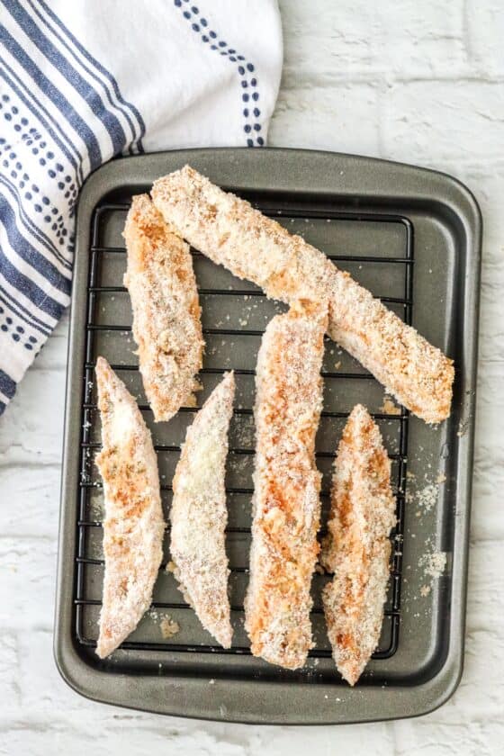 sourdough breadsticks covered with parmesan cheese on wire rack