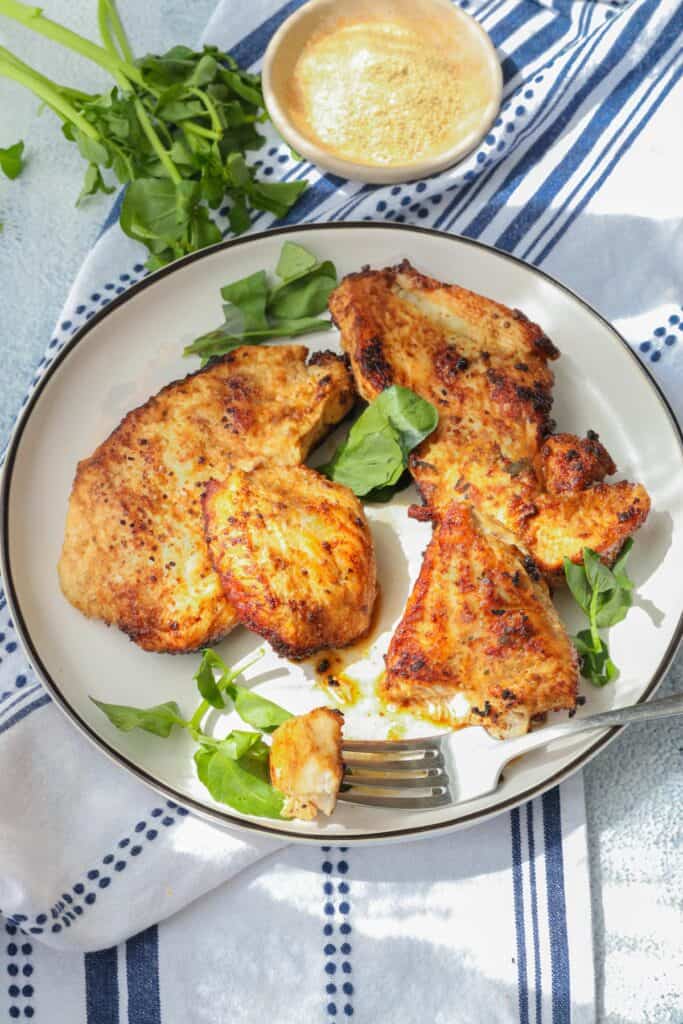 chicken breast topped with herb and fork full