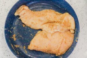 uncooked chicken breast in large bowl