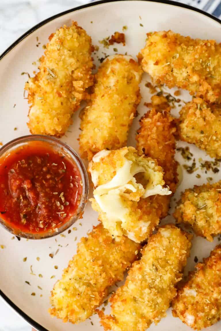 Fried Mozzarella Sticks with dipping sauce in white plate