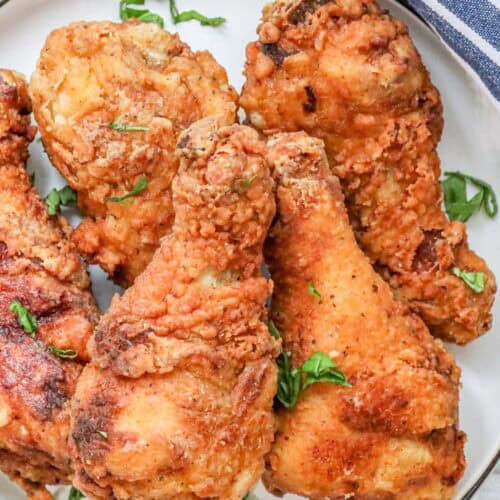 stoked chicken legs recipe with herbs on white plate