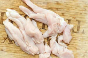 chicken strips on wooden board