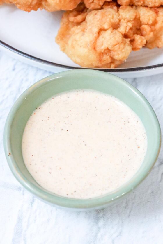 creamy sauce for chicken with fried chicken tenders on white plate