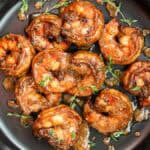 shrimp tossed in jerked seasoning sauce in black plate