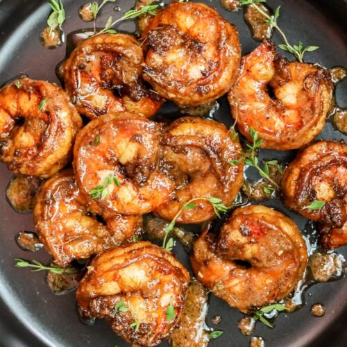 shrimp tossed in jerked seasoning sauce in black plate