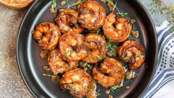 shrimp tossed in jerked seasoning sauce in black plate