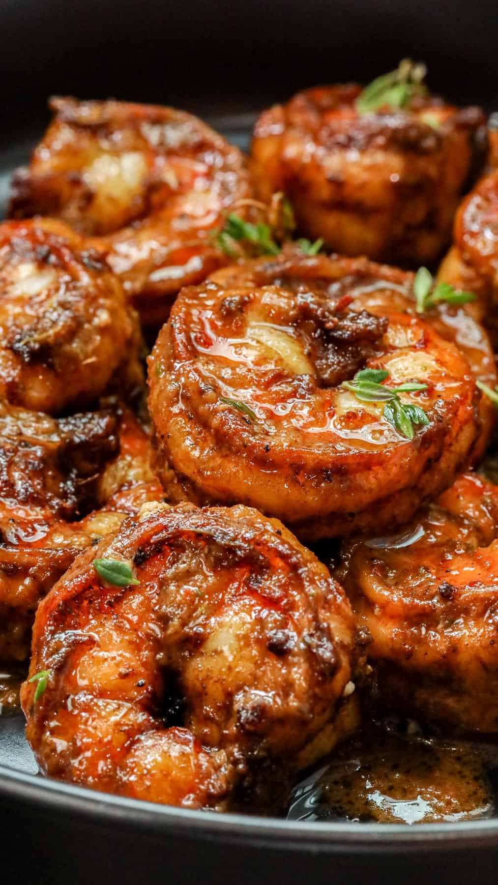 Beautifully coated fried jerked shrimp with jerk sauce in black plate