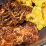 fried turkey backs on board with yellow plantains