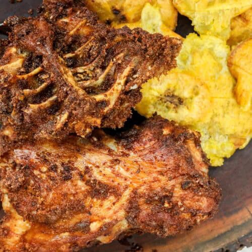 fried turkey backs on board with yellow plantains