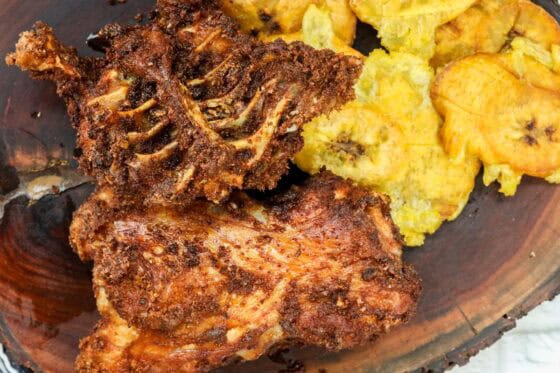 fried turkey backs on board with yellow plantains
