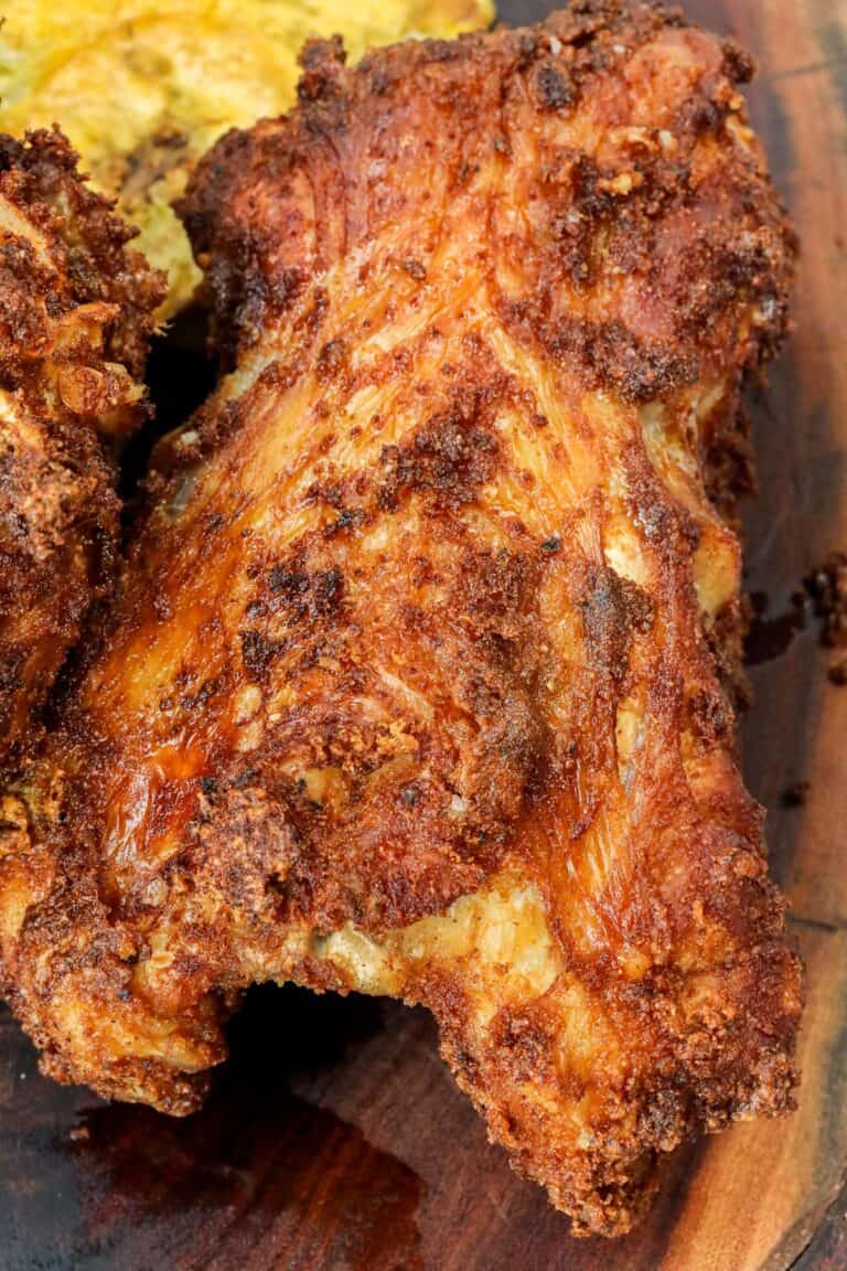 Fried turkey back on wooden spoon