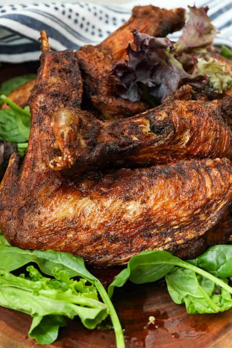 deep fried turkey wings on a bed of green leaves
