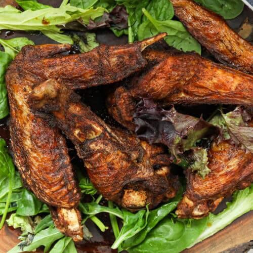 The best fried turkey wings on a bed of green leaves