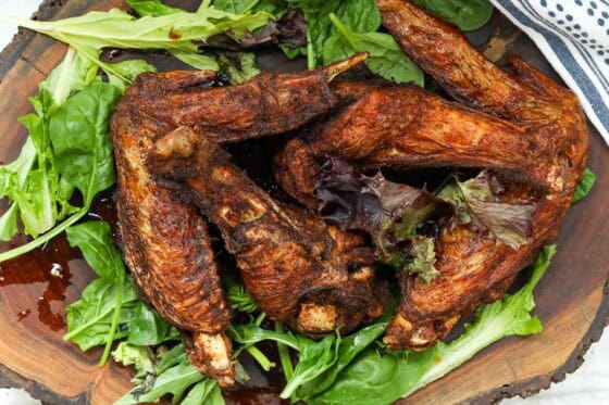 The best fried turkey wings on a bed of green leaves