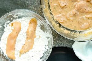 coating chicken strips in flour mixture