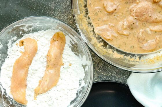 coating chicken strips in flour mixture
