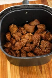 cooked steak bites in air fryer basket