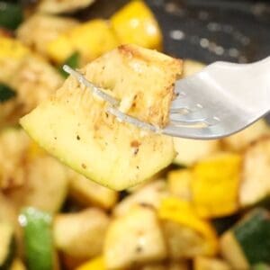 fork holding air fryer zucchini and squash