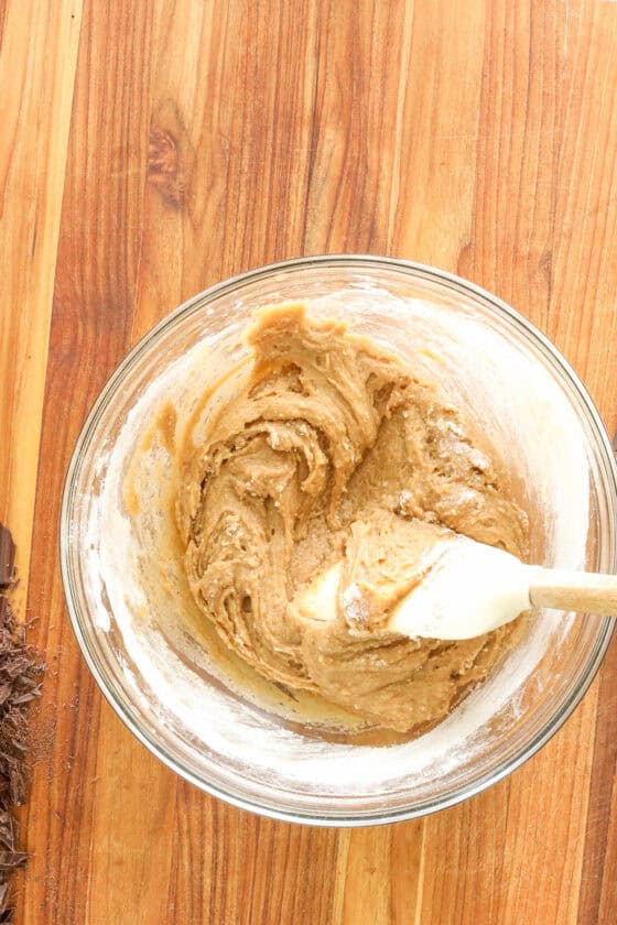mixing cookie dough in glass bowl