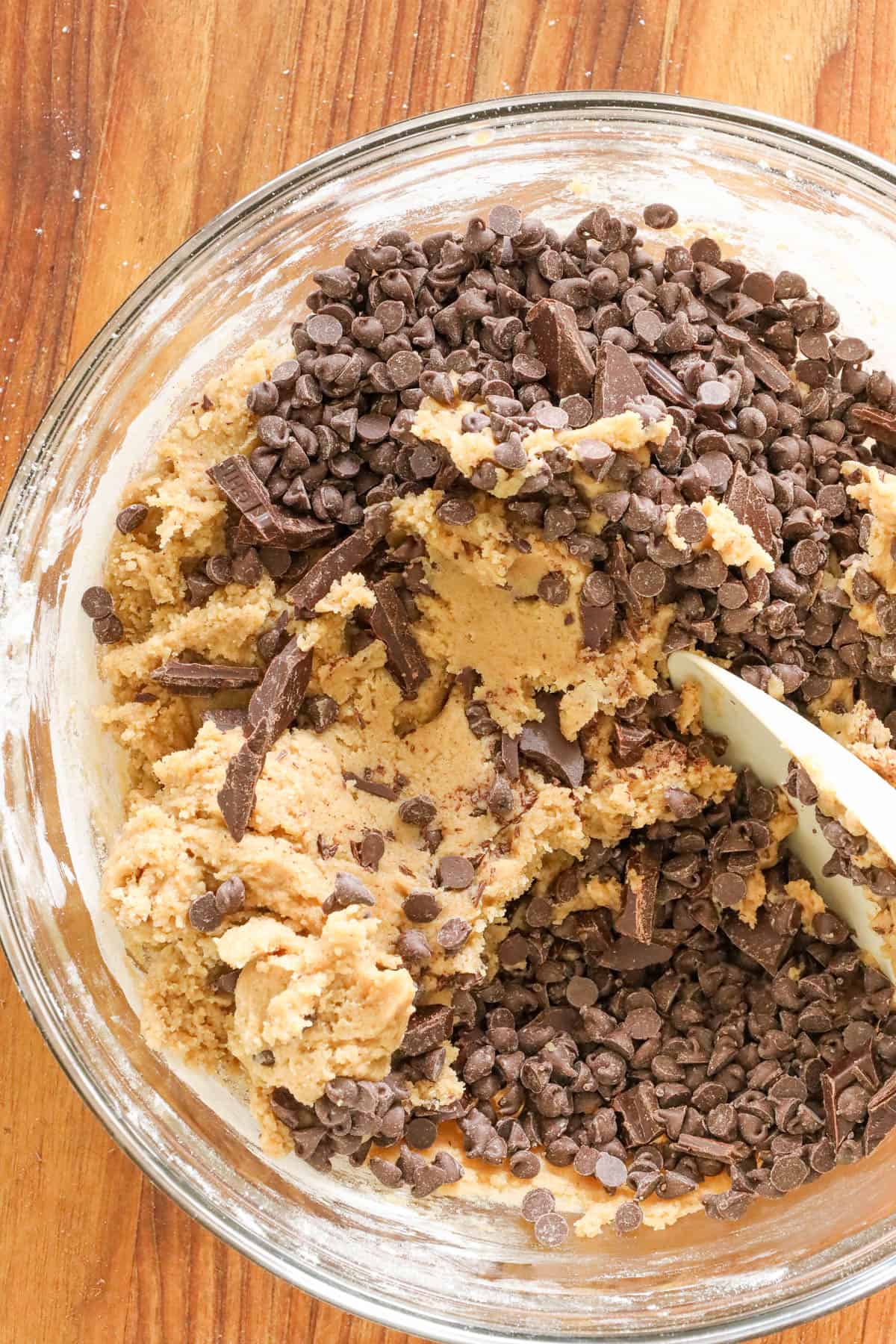 mixing chocolate chips in cookie cake dough