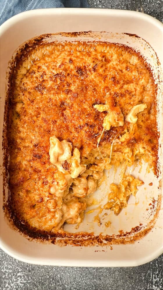 air fryer Mac and cheese in baking dish with a piece missing in the corner