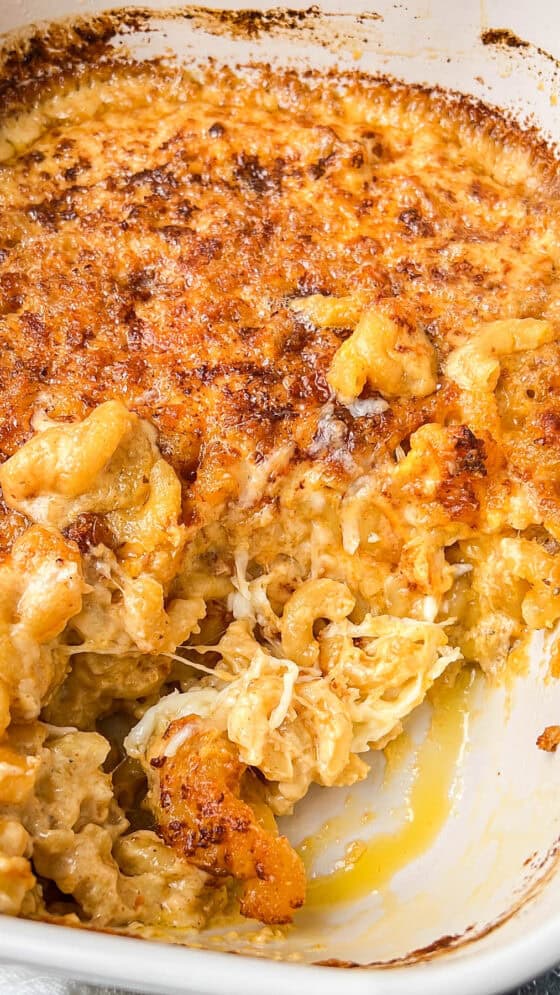 air fryer Mac and cheese in baking dish with a piece missing in the corner