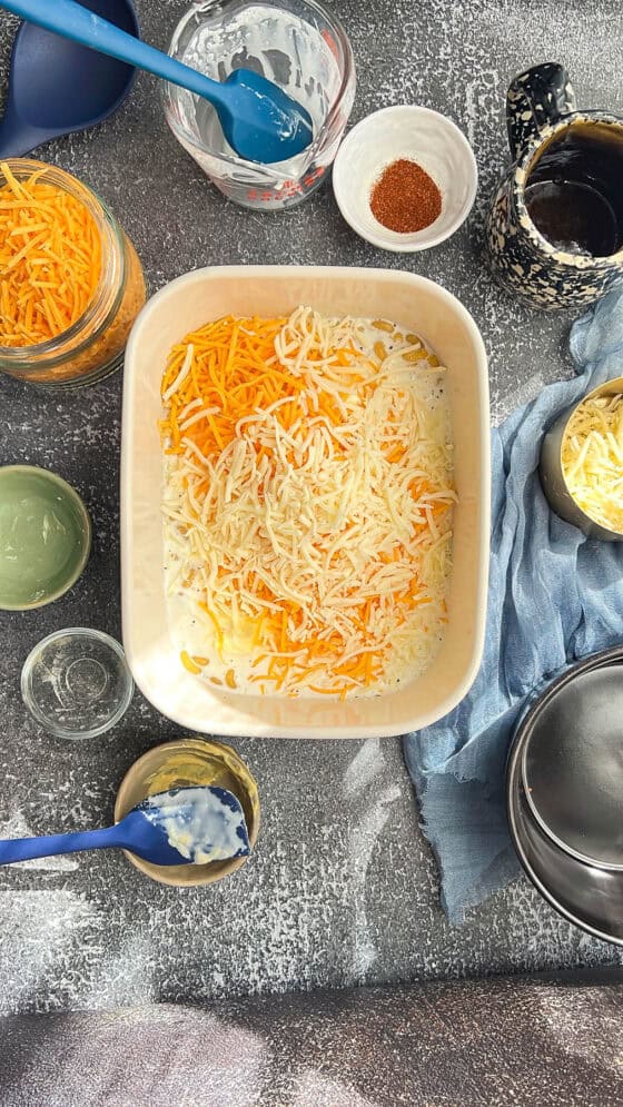 adding cheese on top of Macaroni and milk