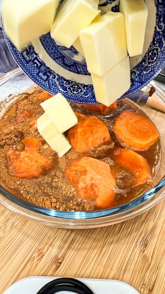 adding butter to sweet potatoes