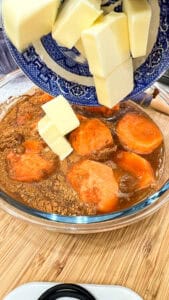 adding butter to sweet potatoes