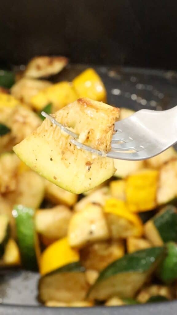 fork holding air fryer zucchini and squash