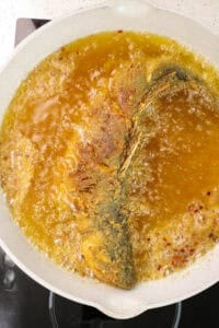 branzino frying in hot oil