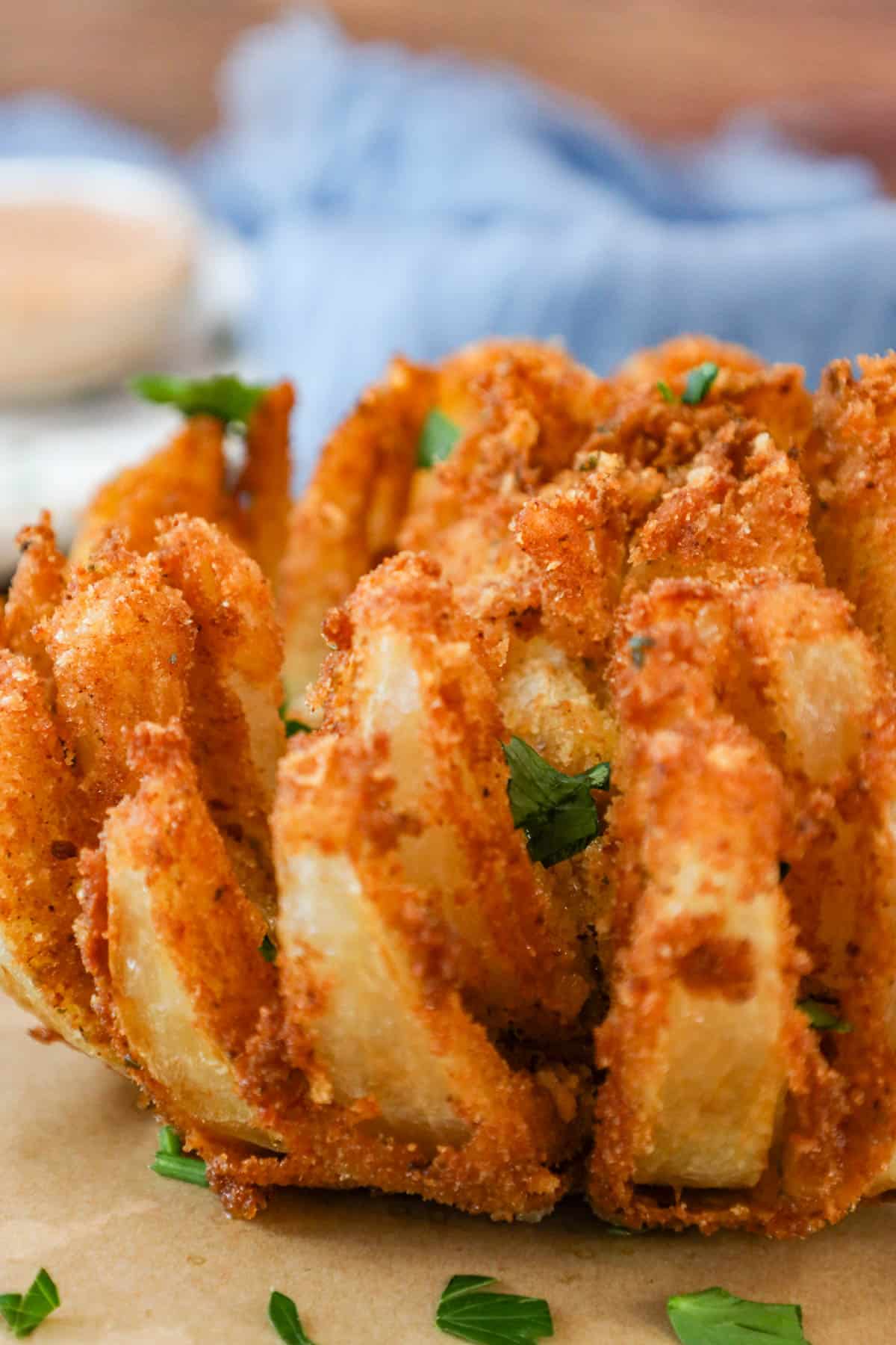 Copycat bloomin onion recipe on parchment paper topped with parsley
