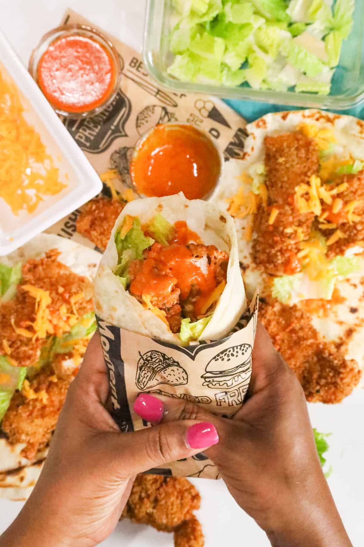 Hand holding Korean Chicken Wrap (Fried)