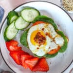 sunny side up fried eggs over a bed or toast with spinach.