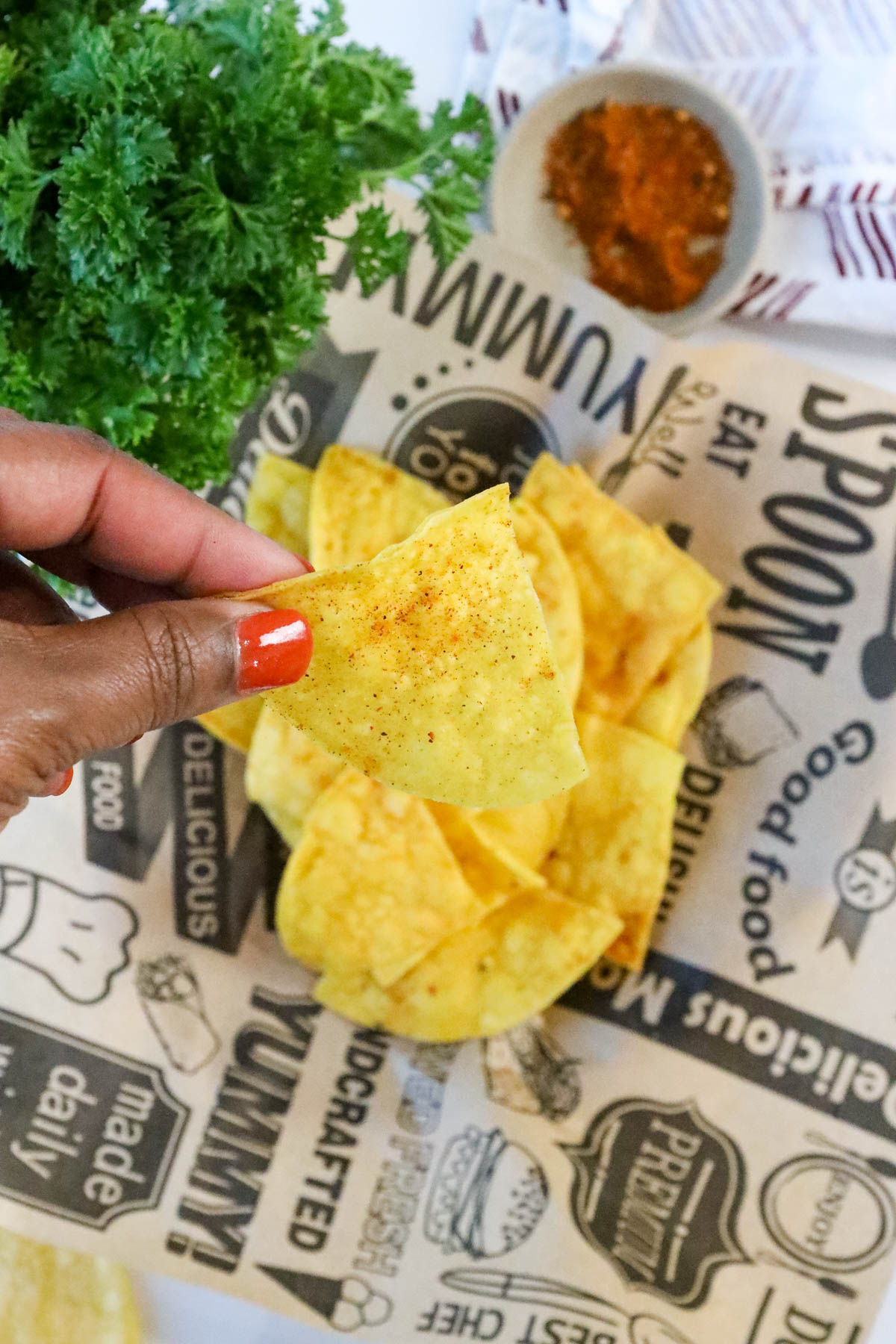 hand holding fried corn tortilla chips