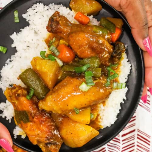 hands holding Air Fryer Curry Chicken