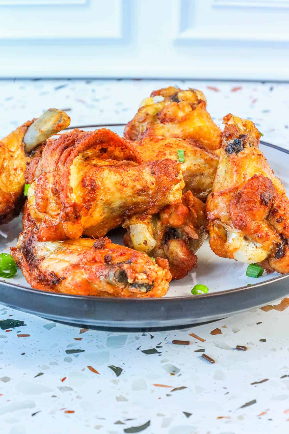 stacked fried wings with no breading on plate